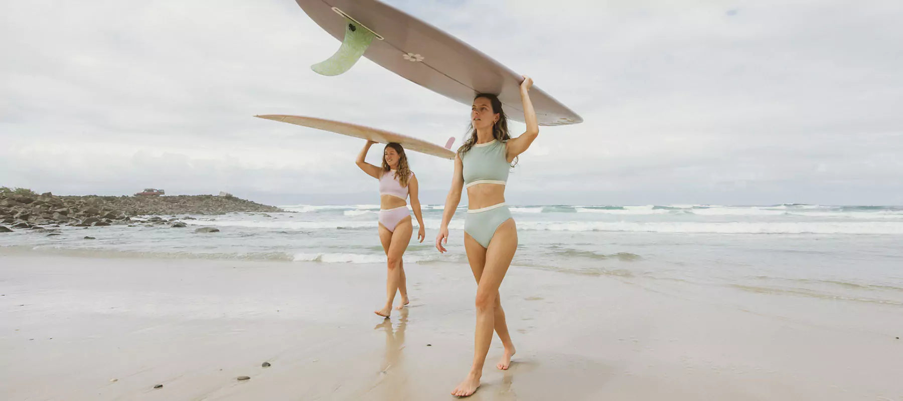 two women about to surf in savu and rote bikini from ninefootstudio surf swimwear collection