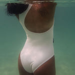 Krui Onepiece Surf Swimsuit in White on the water
