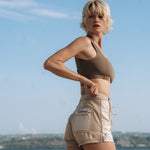 Woman wearing Ninefoot Studio cream surf shorts with contrast stitching – mid-rise tailored fit quick-dry deadstock polyester twill ethically made in Bali