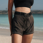 Woman wearing Ninefoot Studio black surf shorts with contrast stitching – mid-rise tailored fit quick-dry deadstock polyester twill ethically made in Bali