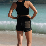 Woman wearing Ninefoot Studio black surf shorts with contrast stitching – mid-rise tailored fit quick-dry deadstock polyester twill ethically made in Bali