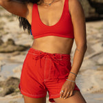 Woman wearing Ninefoot Studio red surf shorts with contrast stitching – mid-rise tailored fit quick-dry deadstock polyester twill ethically made in Bali