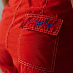 Woman wearing Ninefoot Studio red surf shorts with contrast stitching – mid-rise tailored fit quick-dry deadstock polyester twill ethically made in Bali