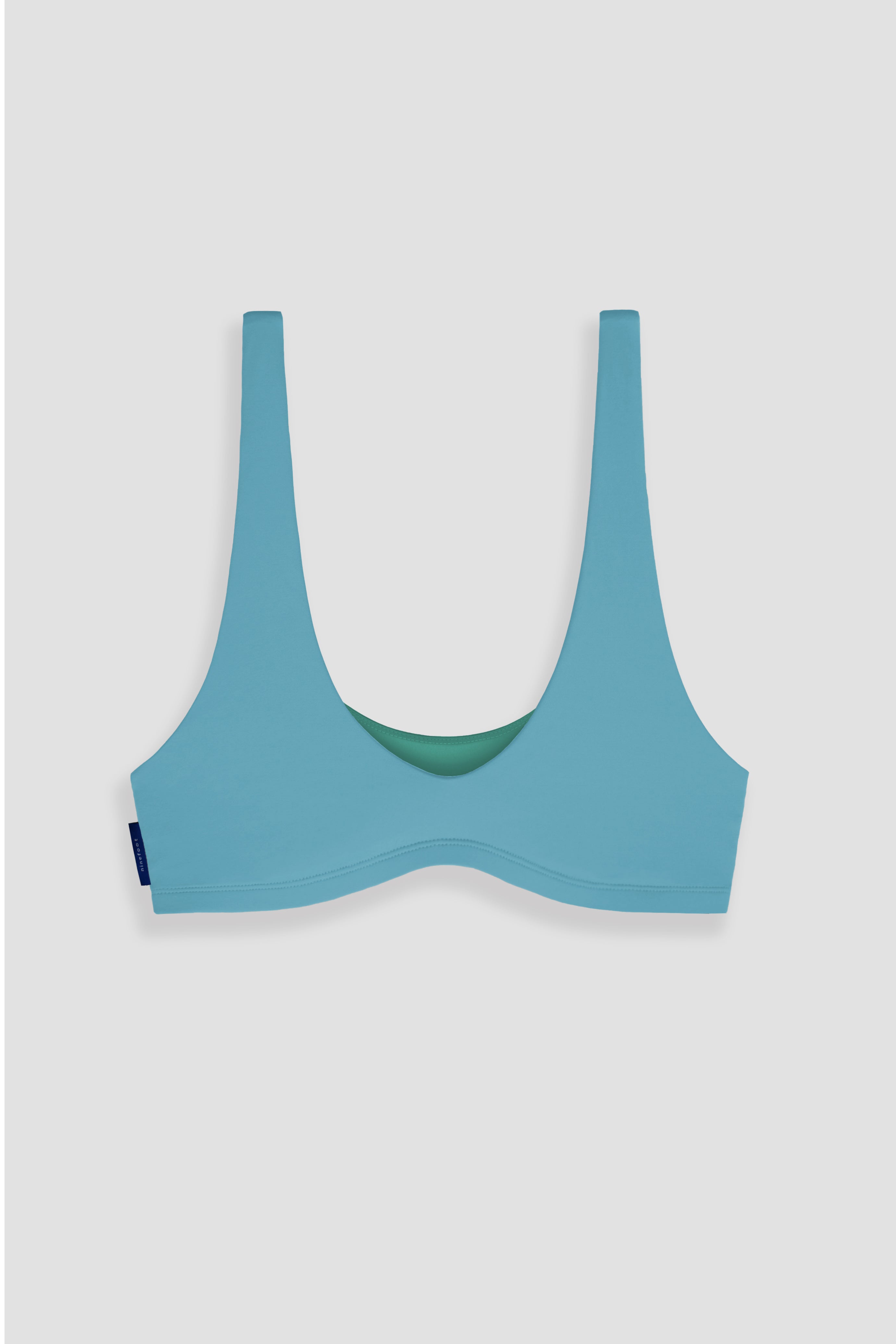 nias surf top in stone blue color flat image front side