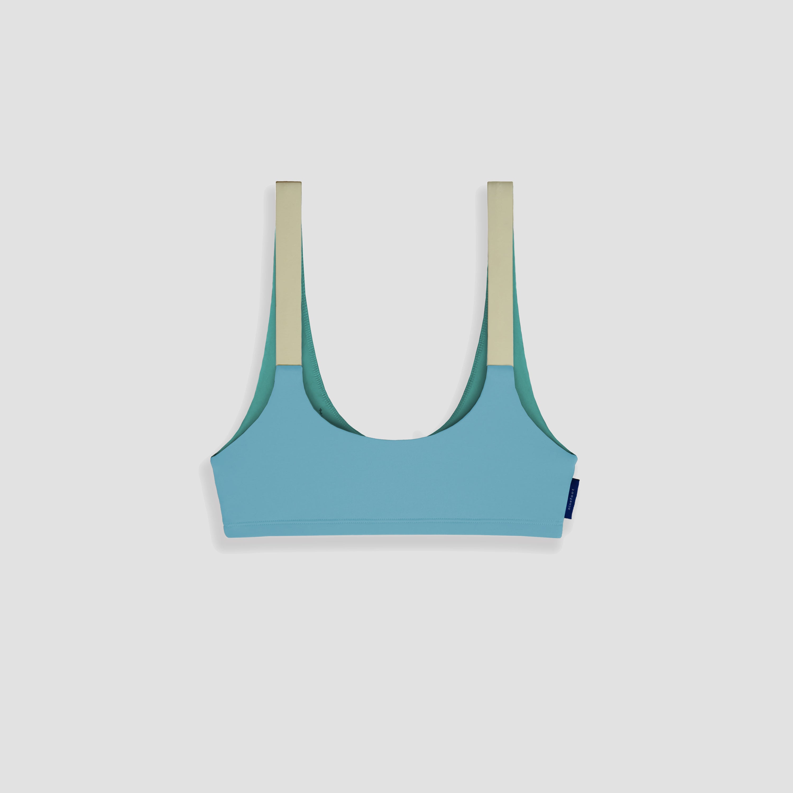 nias surf top in stone blue color flat image back side