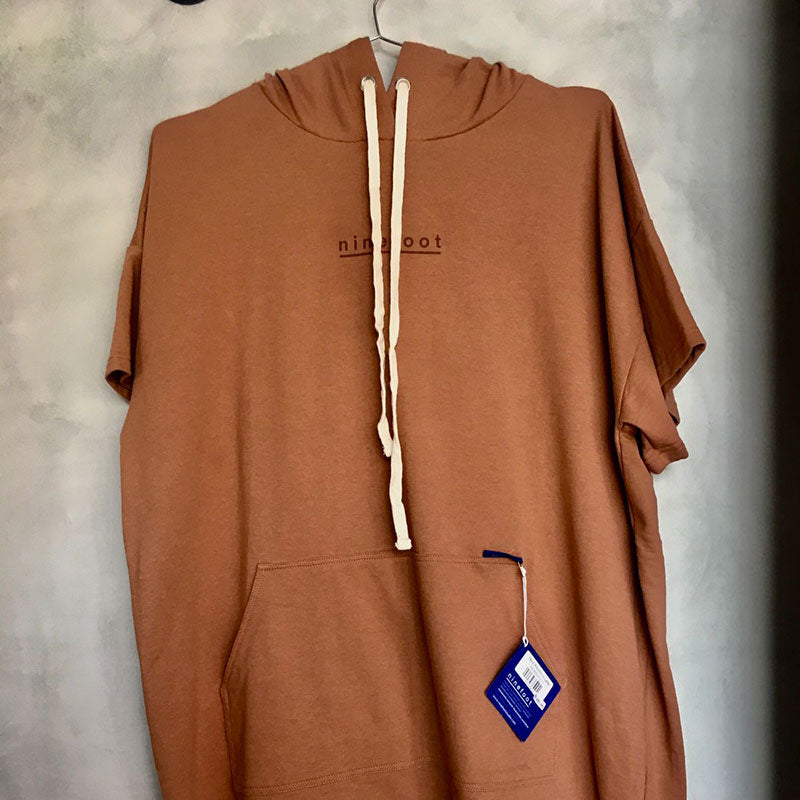 nico surf poncho with hoodie in latte color store display front side